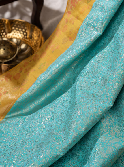 Light Blue Kanchipuram Silk Saree With Silver Brocade In Contrast Yellow Border
