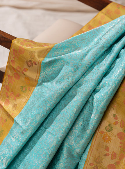 Light Blue Kanchipuram Silk Saree With Silver Brocade In Contrast Yellow Border