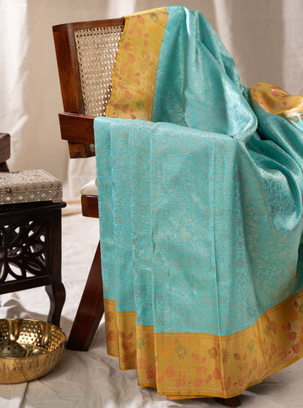 Light Blue Kanchipuram Silk Saree With Silver Brocade In Contrast Yellow Border