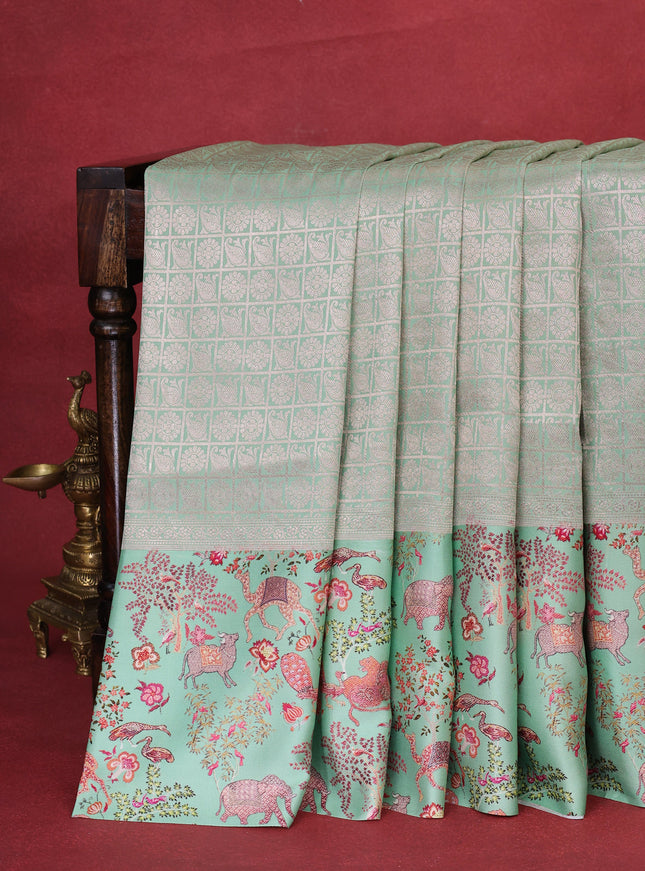 Pastel Green Banarasi Silk Saree With Allover Zari Weaves & Satin Border Prints