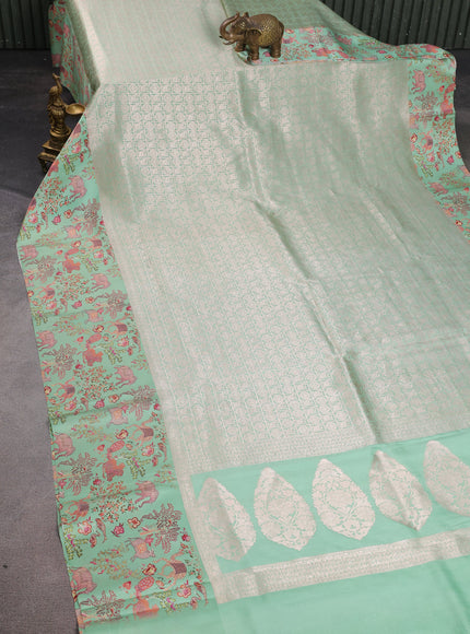 Pastel Green Banarasi Silk Saree With Allover Zari Weaves & Satin Border Prints