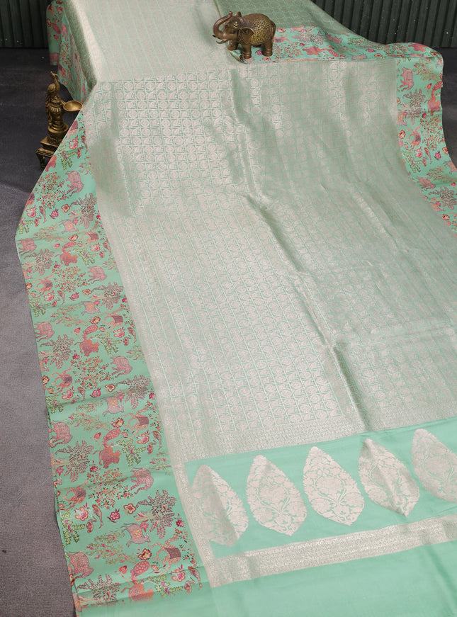 Pastel Green Banarasi Silk Saree With Allover Zari Weaves & Satin Border Prints