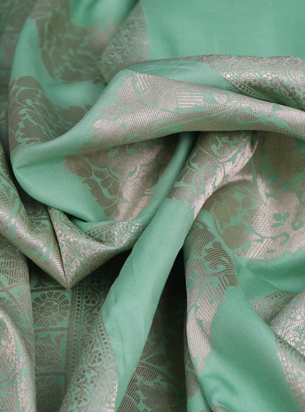 Pastel Green Banarasi Silk Saree With Allover Zari Weaves & Satin Border Prints